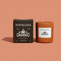 Nopalera Ibarra scented candle and packaging on a brown background