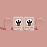 Two Nopalera cactus soap bars with matching blush-toned soap against a soft pink background.