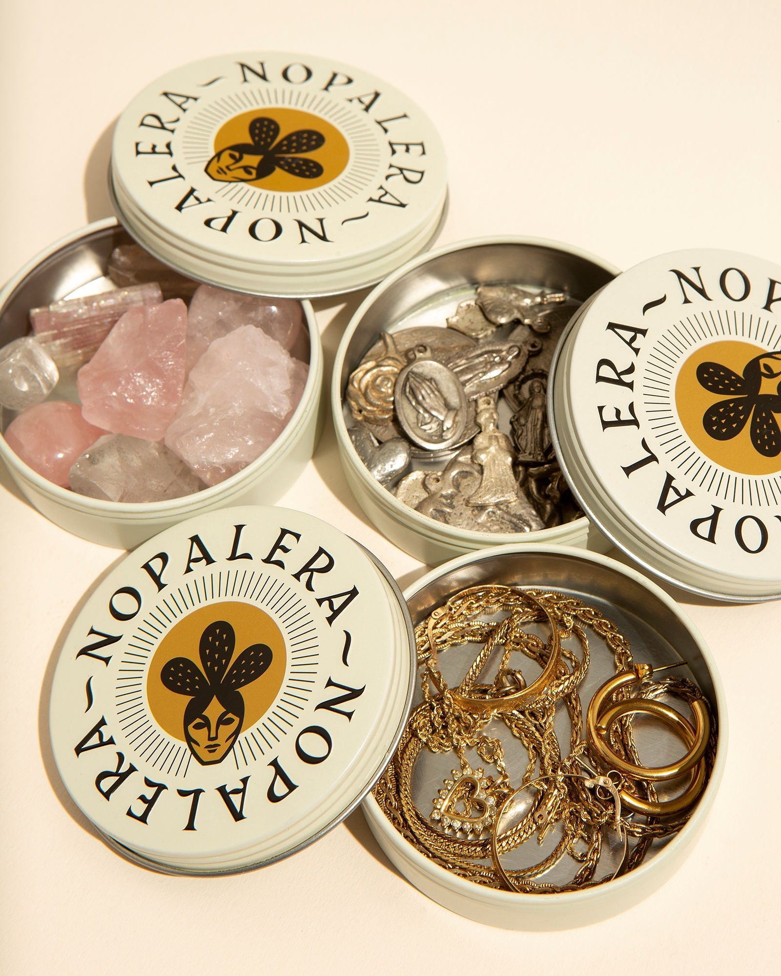 Nopalera jewelry dishes filled with rings, necklaces, and crystals styled in a minimal flat lay arrangement.