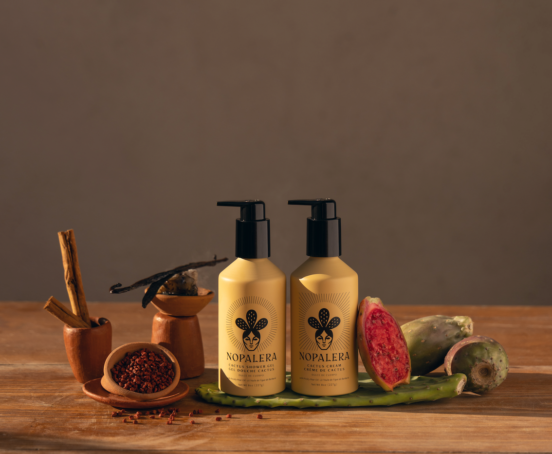 Bottles of clean fragrances next to natural ingredients
