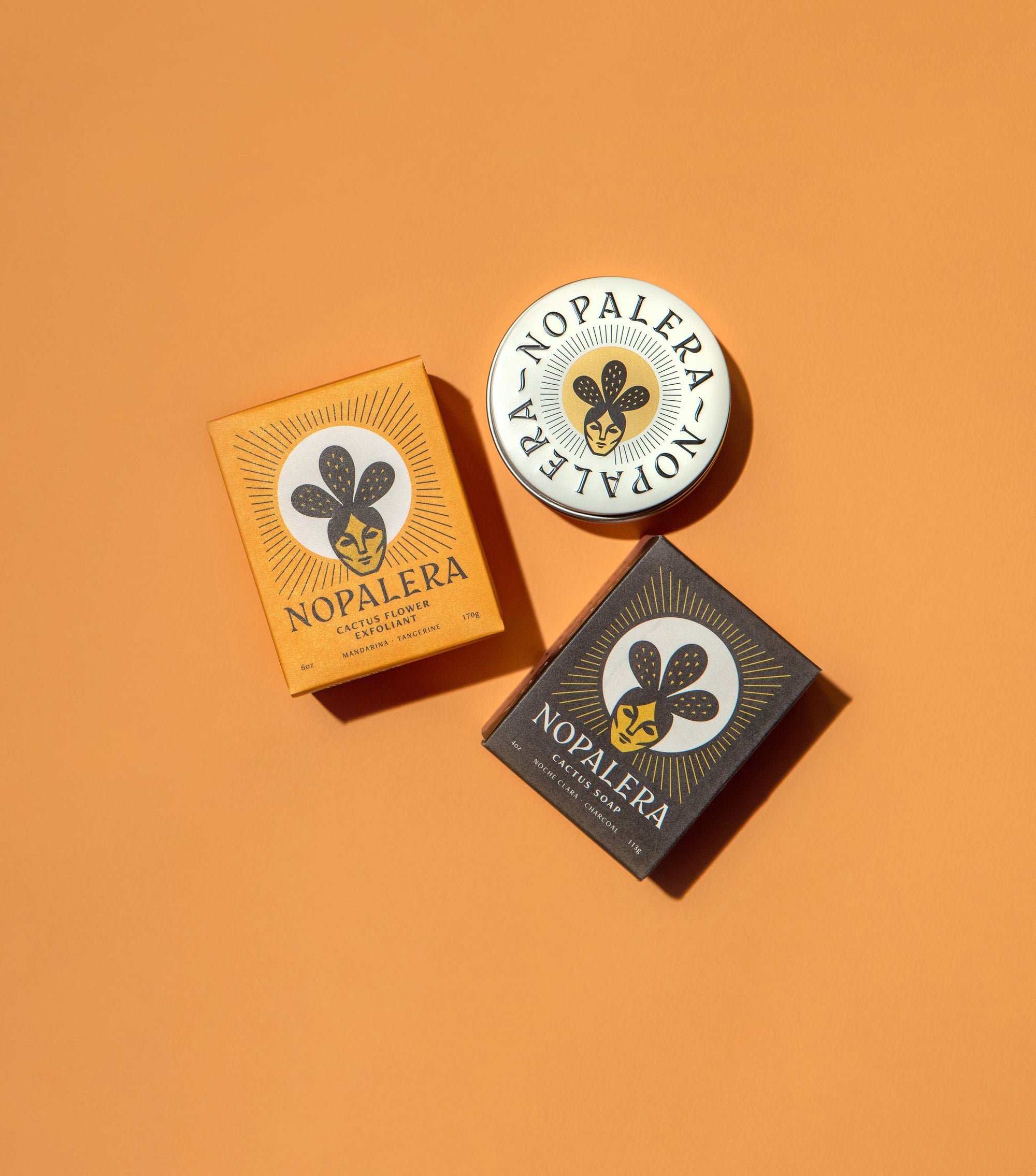 Nopalera body care products styled against a warm orange background.