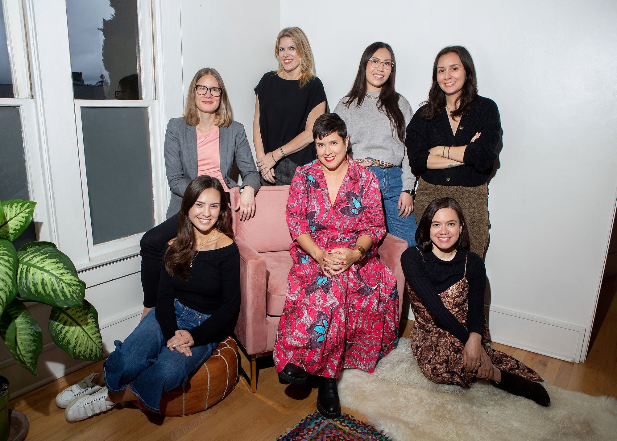 Nopalera team portrait with Sandra Velazquez seated in the center, surrounded by team members in a studio setting.