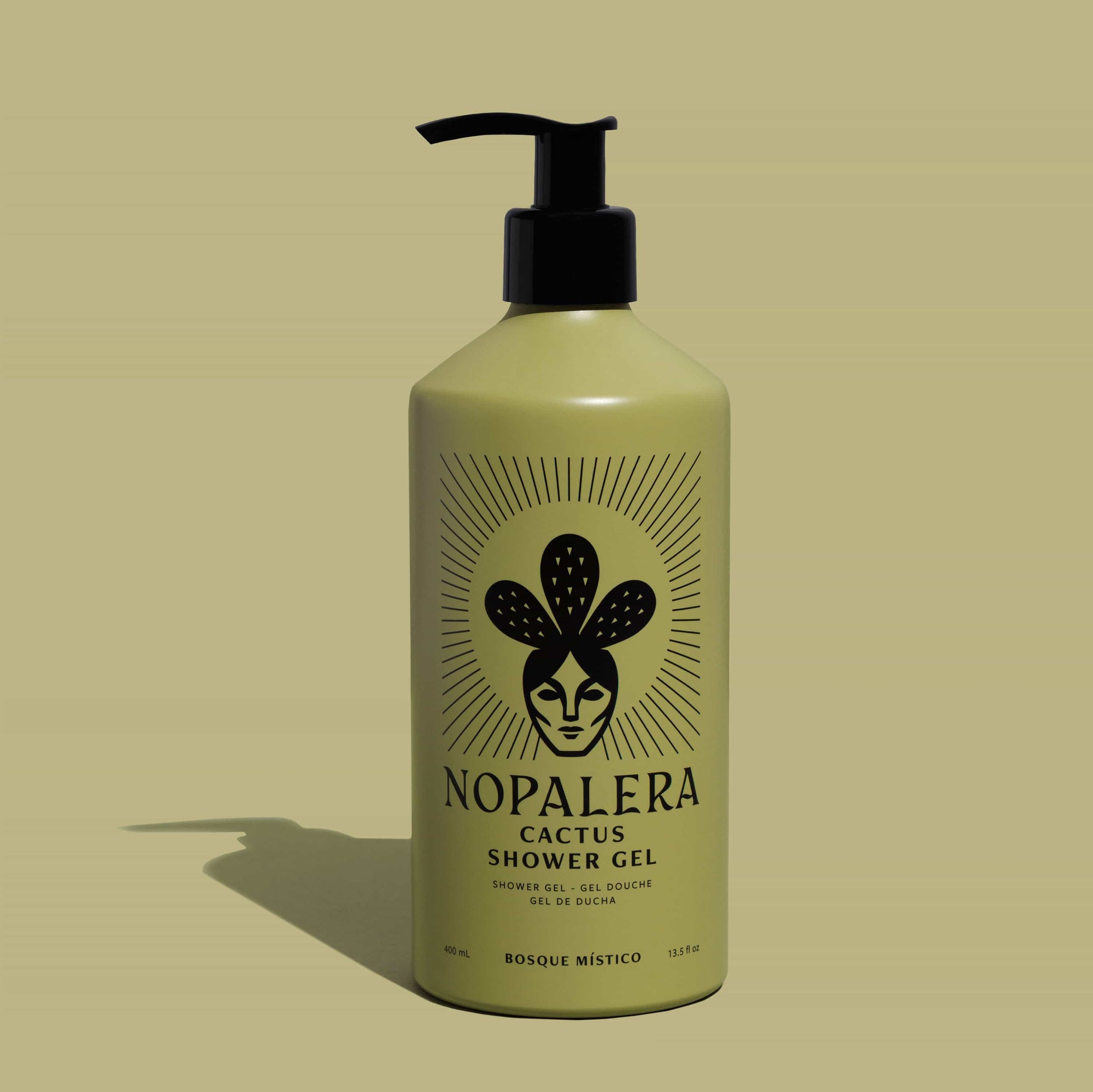 A bottle of Nopalera Cactus Shower Gel with a black pump dispenser and a black graphic label, set against a solid olive-green background with a soft shadow.