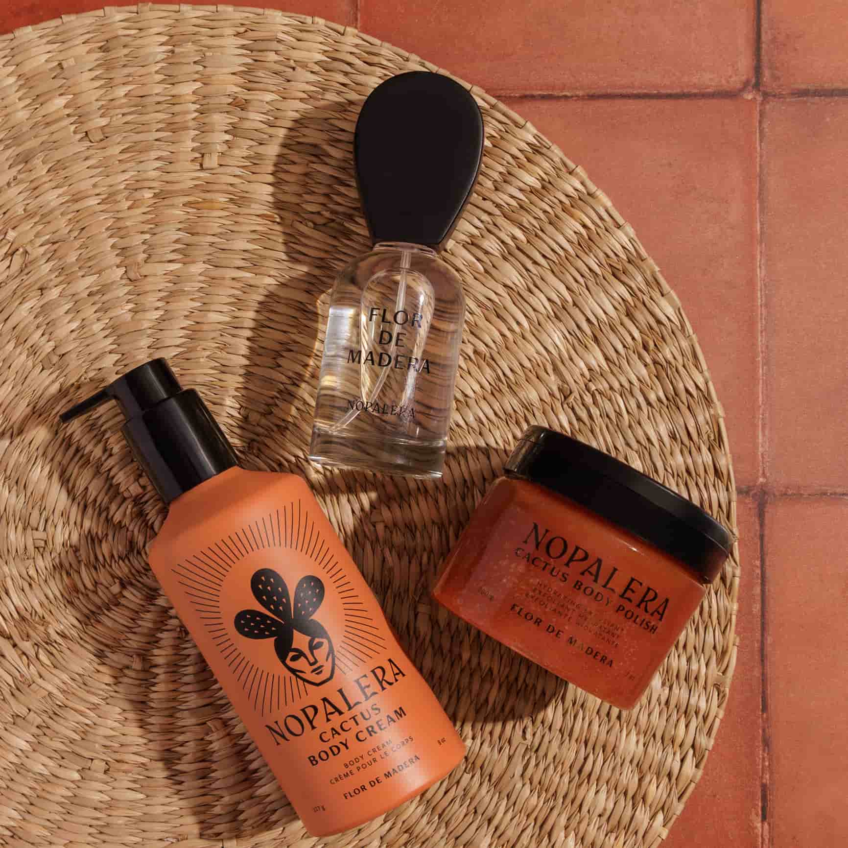 Nopalera Flor de Madera skincare products on a woven mat with a terracotta tile background
