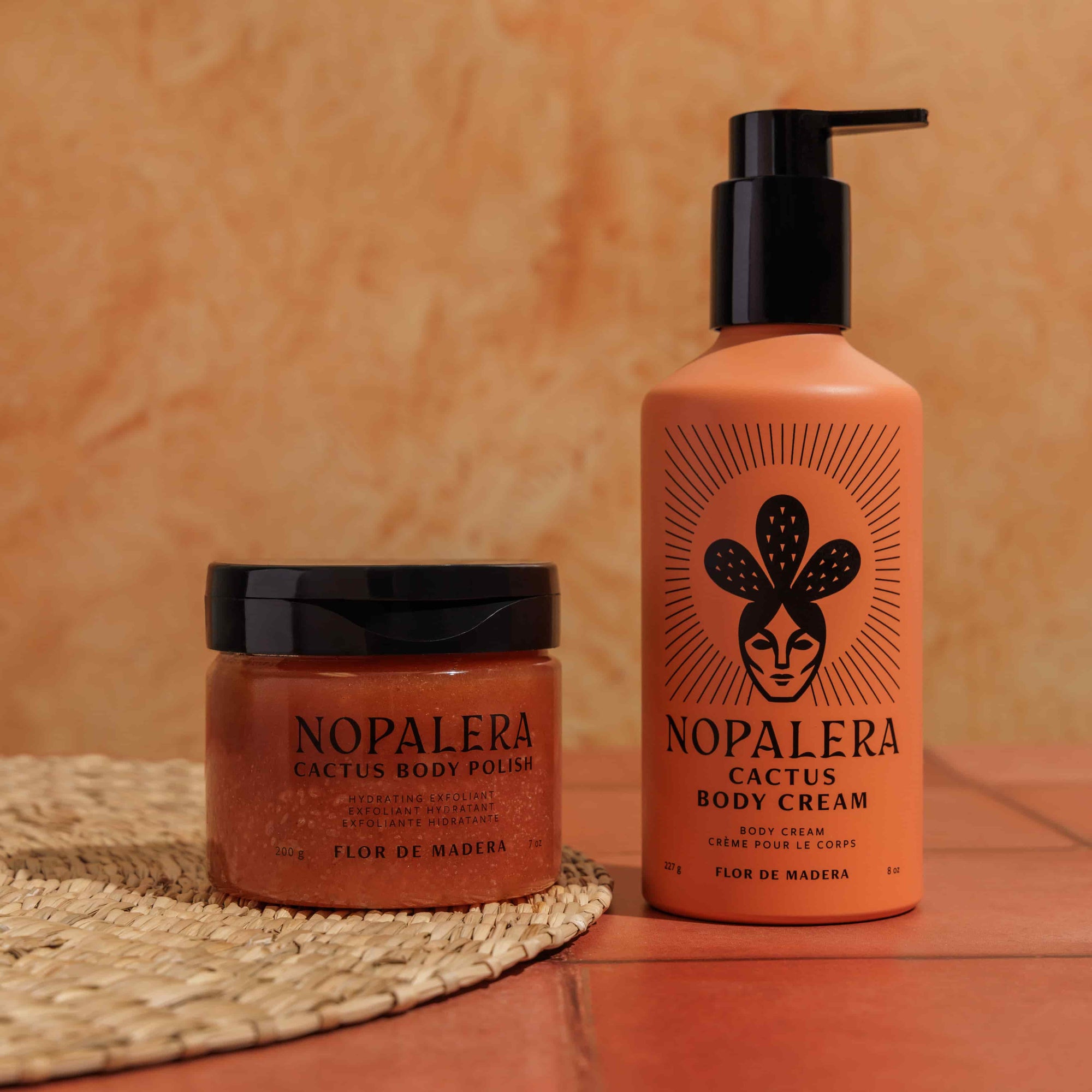 Nopalera cactus body polish and cream  Flor de Madera  on a textured surface with an orange background