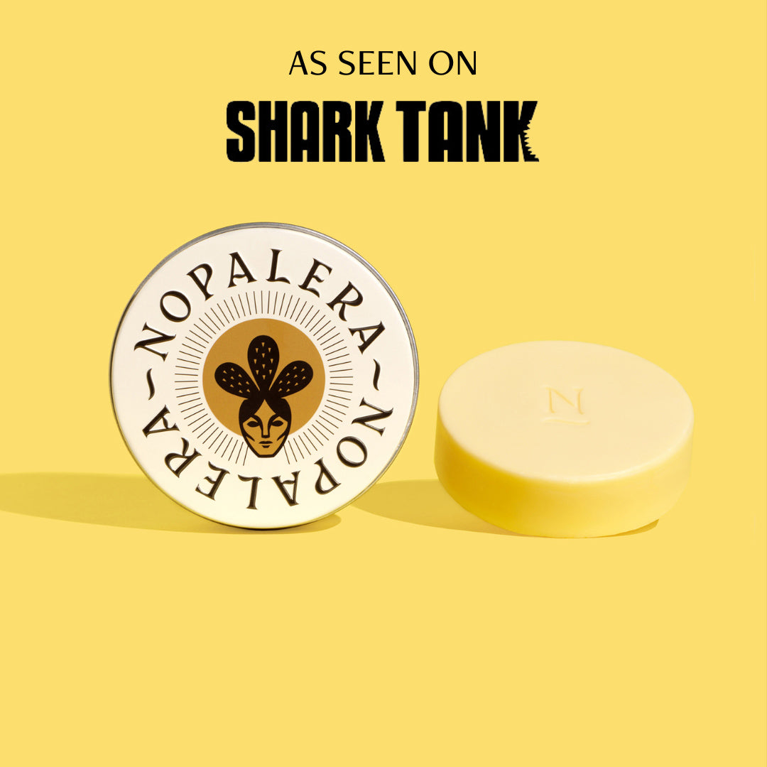 A white lotion bar displayed in front of a tin with the Nopalera brand logo. The background is yellow with the text 'AS SEEN ON SHARK TANK' at the top.