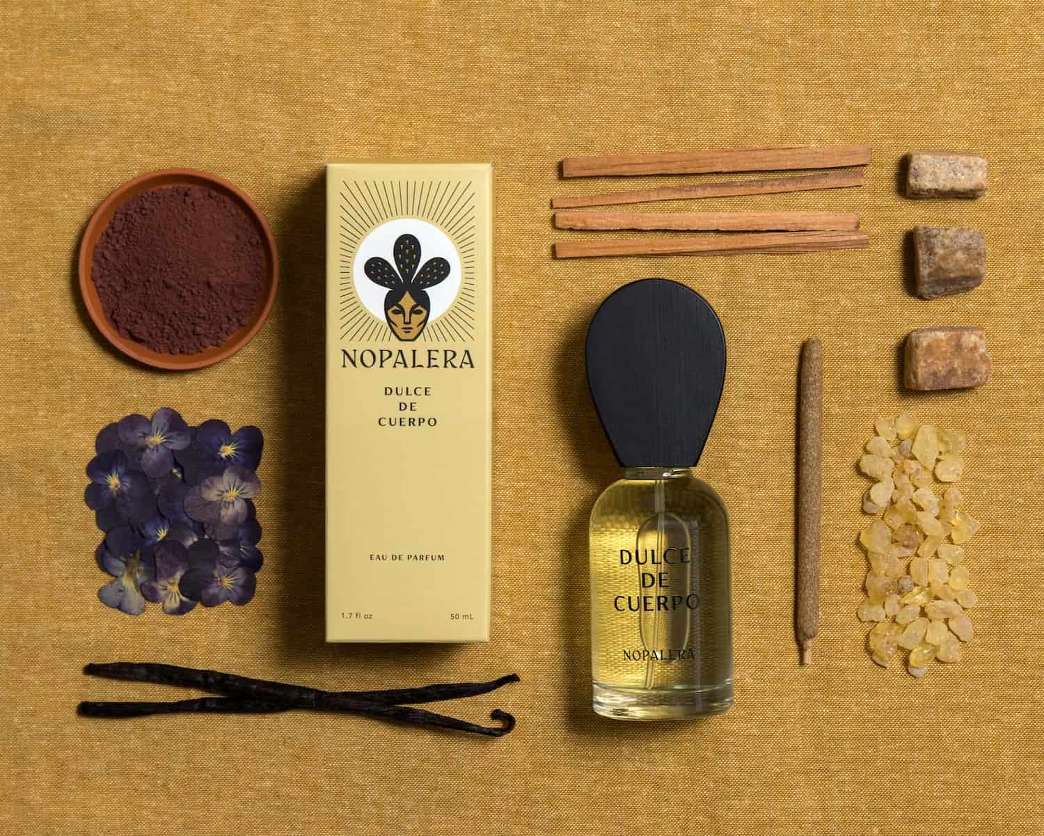Nopalera perfume bottle with packaging and ingredients on a textured surface