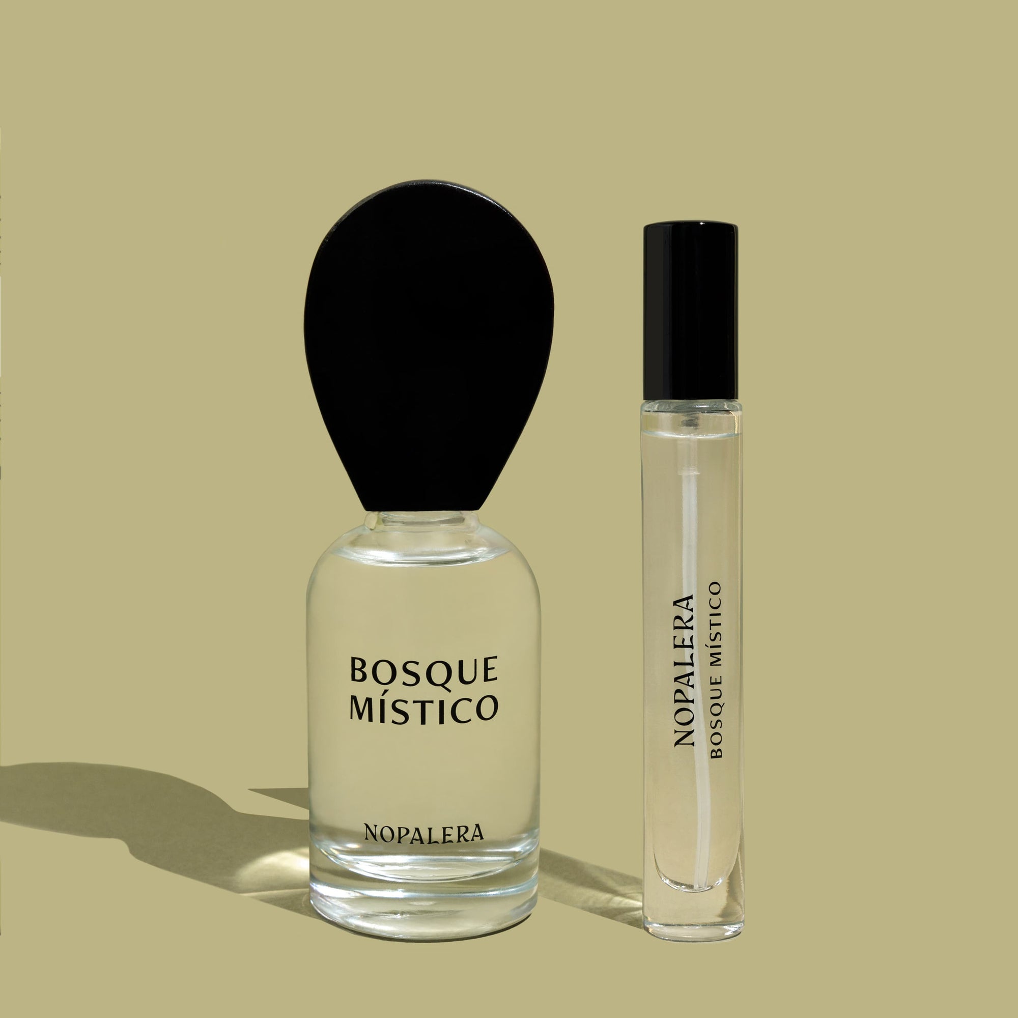 Two Nopalera Bosque Místico perfume bottles, including a 50ml Eau de Parfum and a 10ml travel spray on a beige background