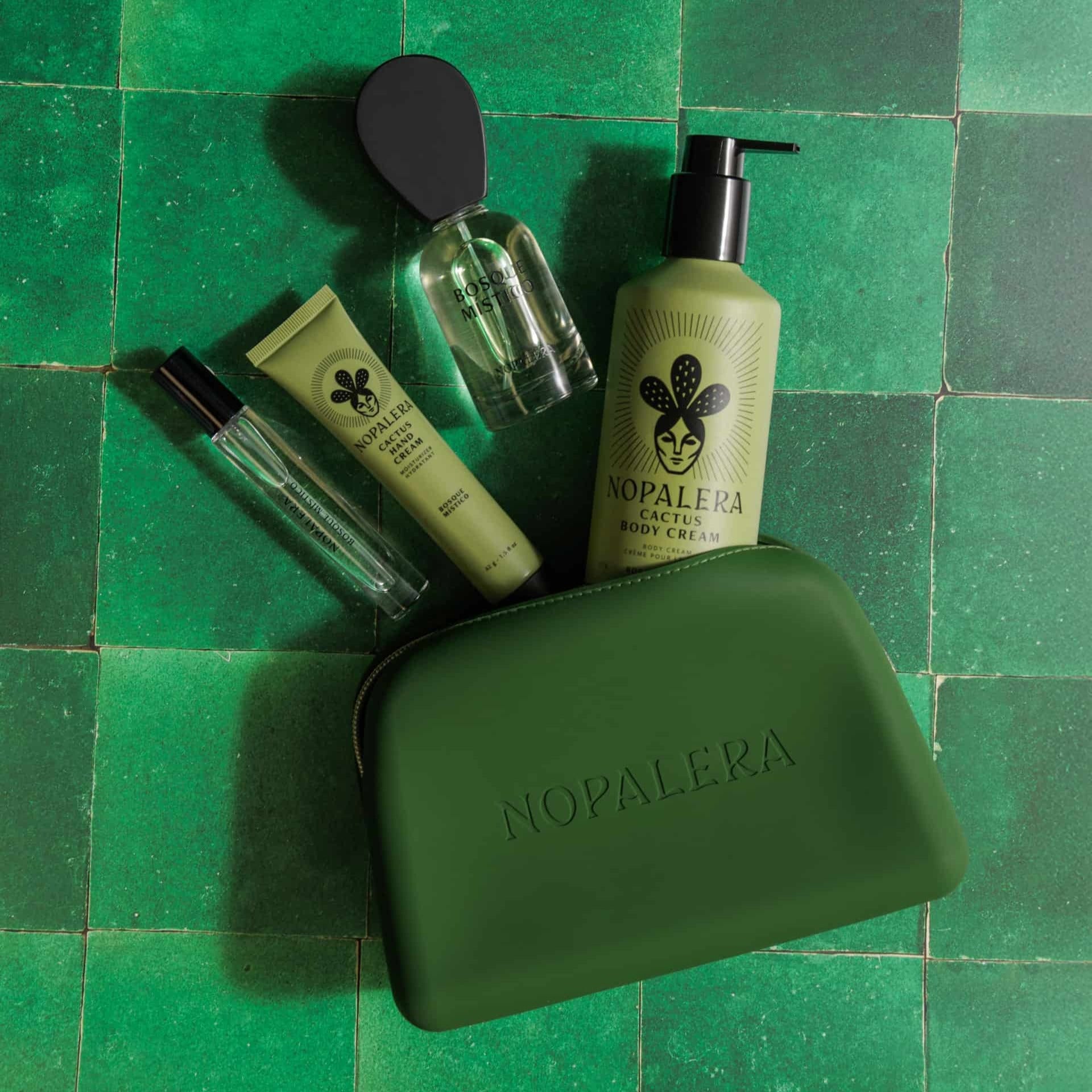 Nopalera skincare products on a green tiled background and a Green nopalera.momsmetic pouch with gold zipper and embossed logo 