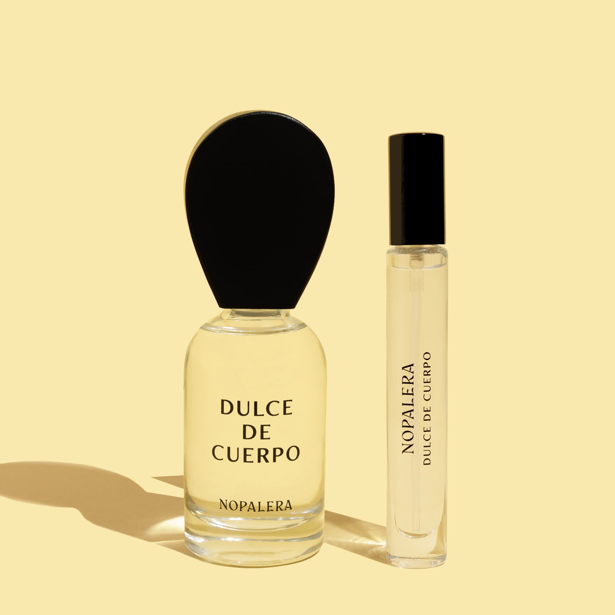 Two Nopalera Dulce de Cuerpo perfume bottles, including a 50ml Eau de Parfum and a 10ml travel spray on a beige background