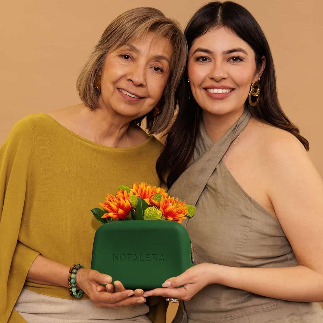 Mother's day Nopalera gift with purchase. A Green nopalera.momsmetic pouch with gold zipper and embossed logo.