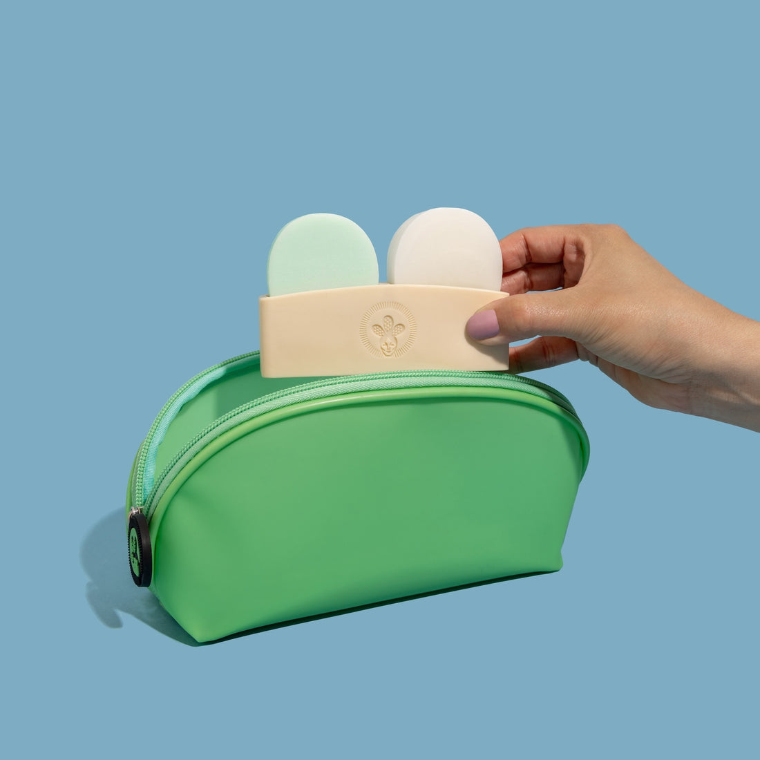 Nopalera shampoo and conditioner bars with green storage pouch on a light blue background