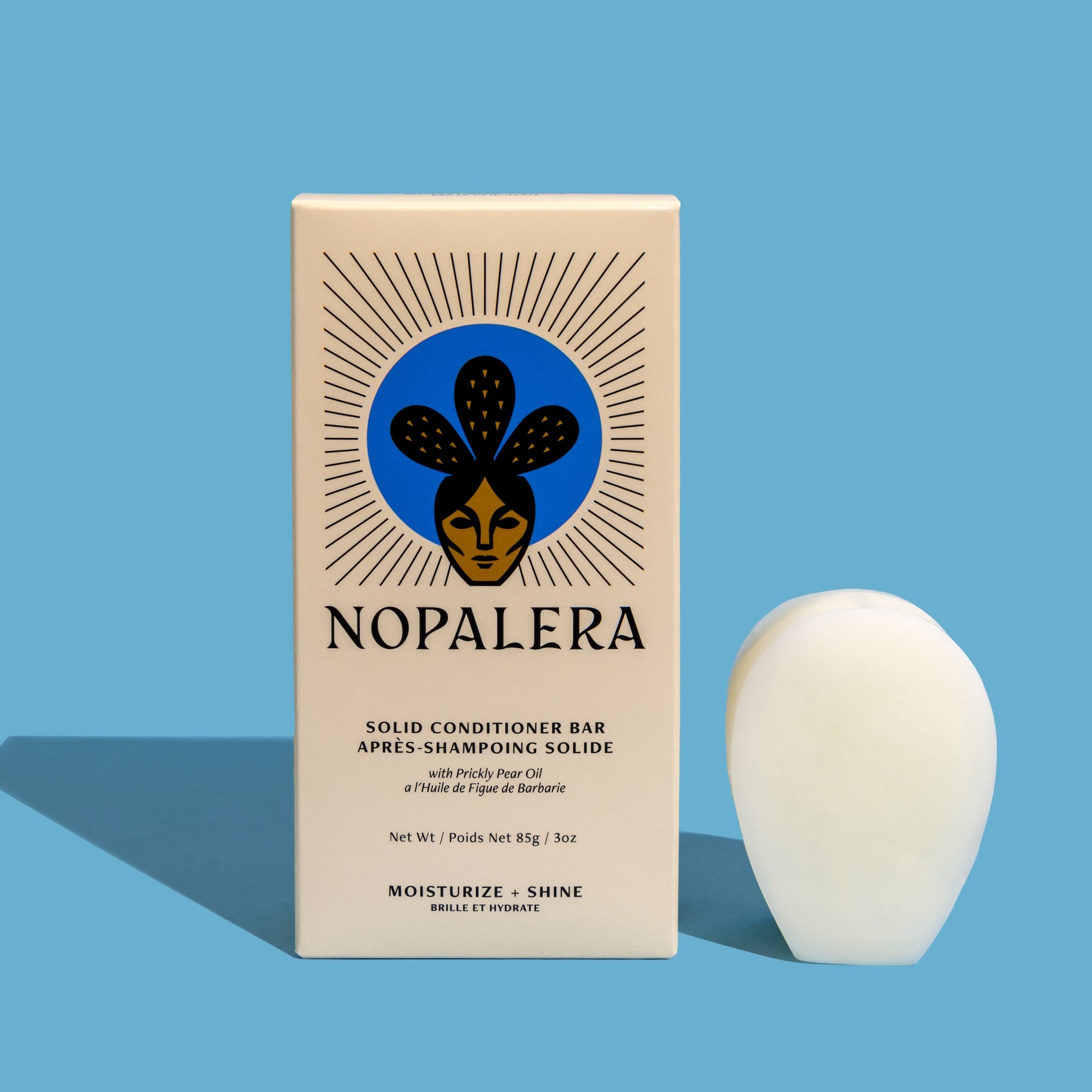 Packaged Nopalera solid conditioner bar displayed beside its box for moisturizing and shine.