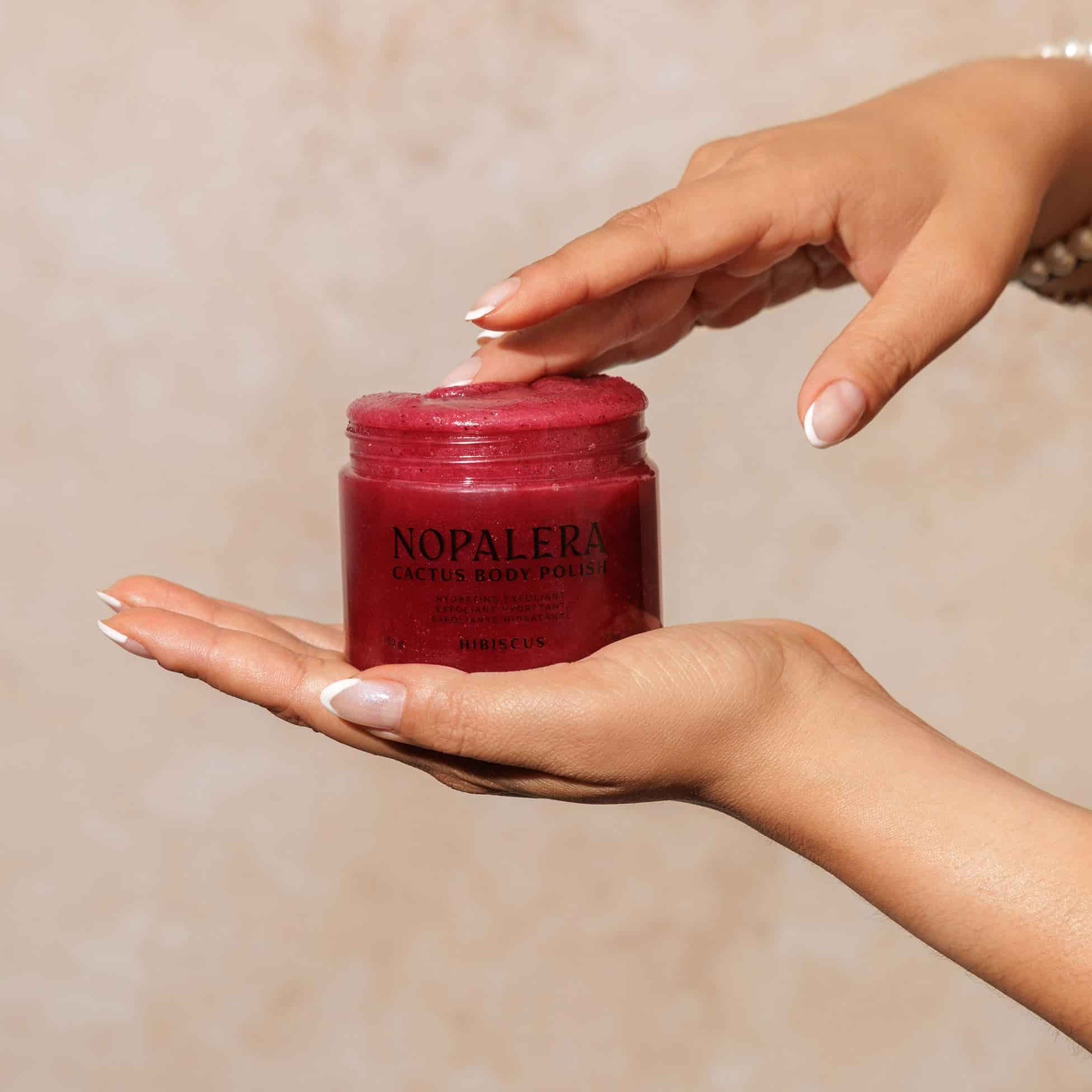 Red jar labeled 'Nopalera' with Hibiscus body polish