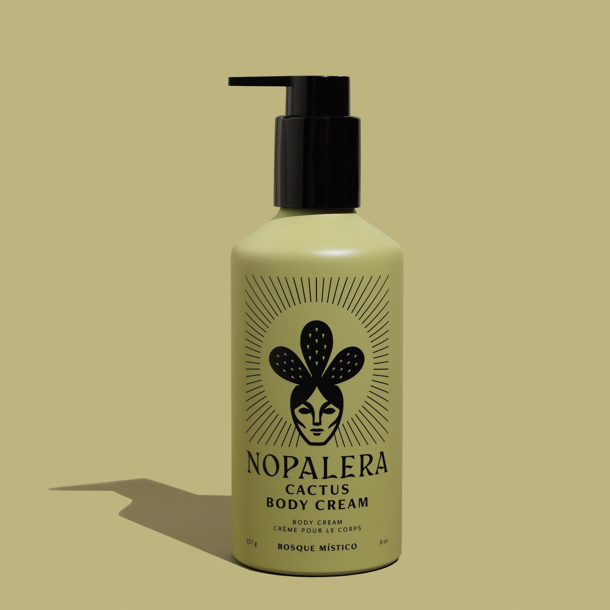 A green pump bottle of Nopalera Bosque Místico Body Cream with a graphic of a cactus and the text 'Bosque Místico' on the label.