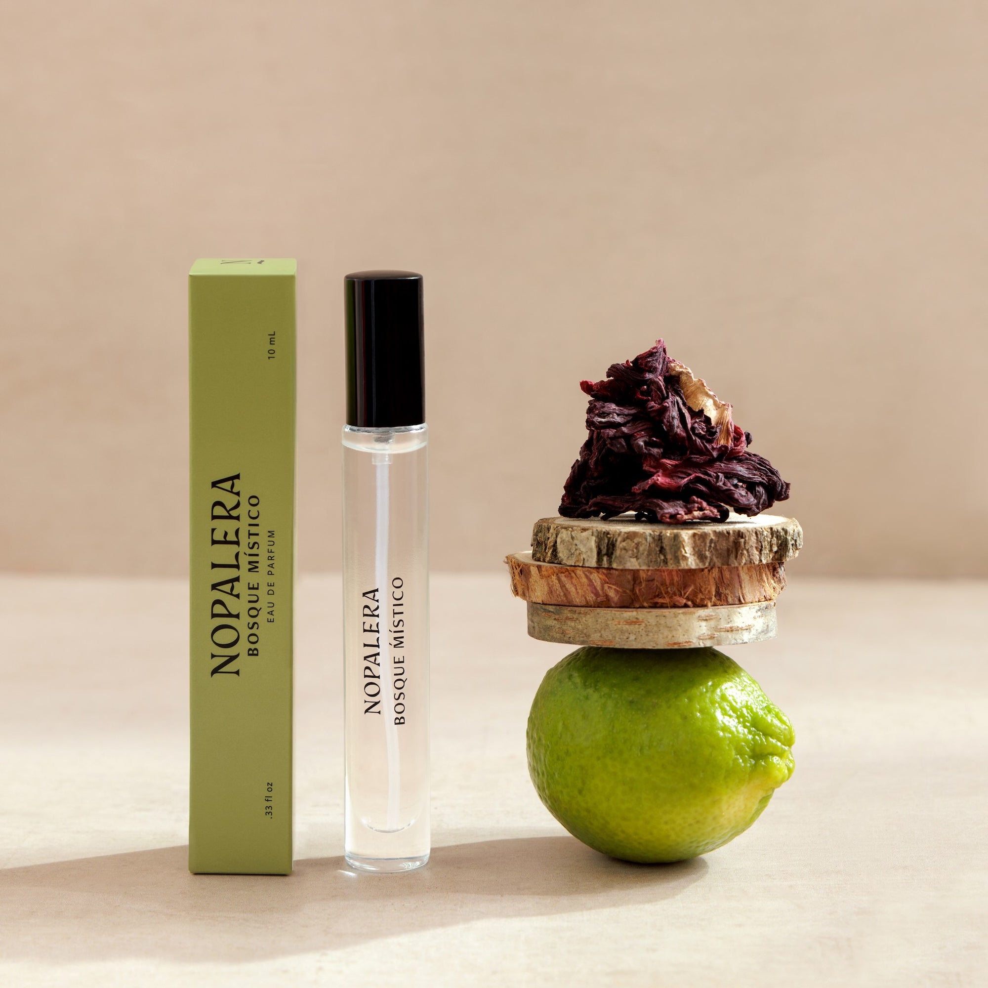 Nopalera  Luxury Mexican travel spray perfume bottle and packaging with a lime and dried flowers on a neutral background