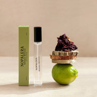Nopalera  Luxury Mexican travel spray perfume bottle and packaging with a lime and dried flowers on a neutral background