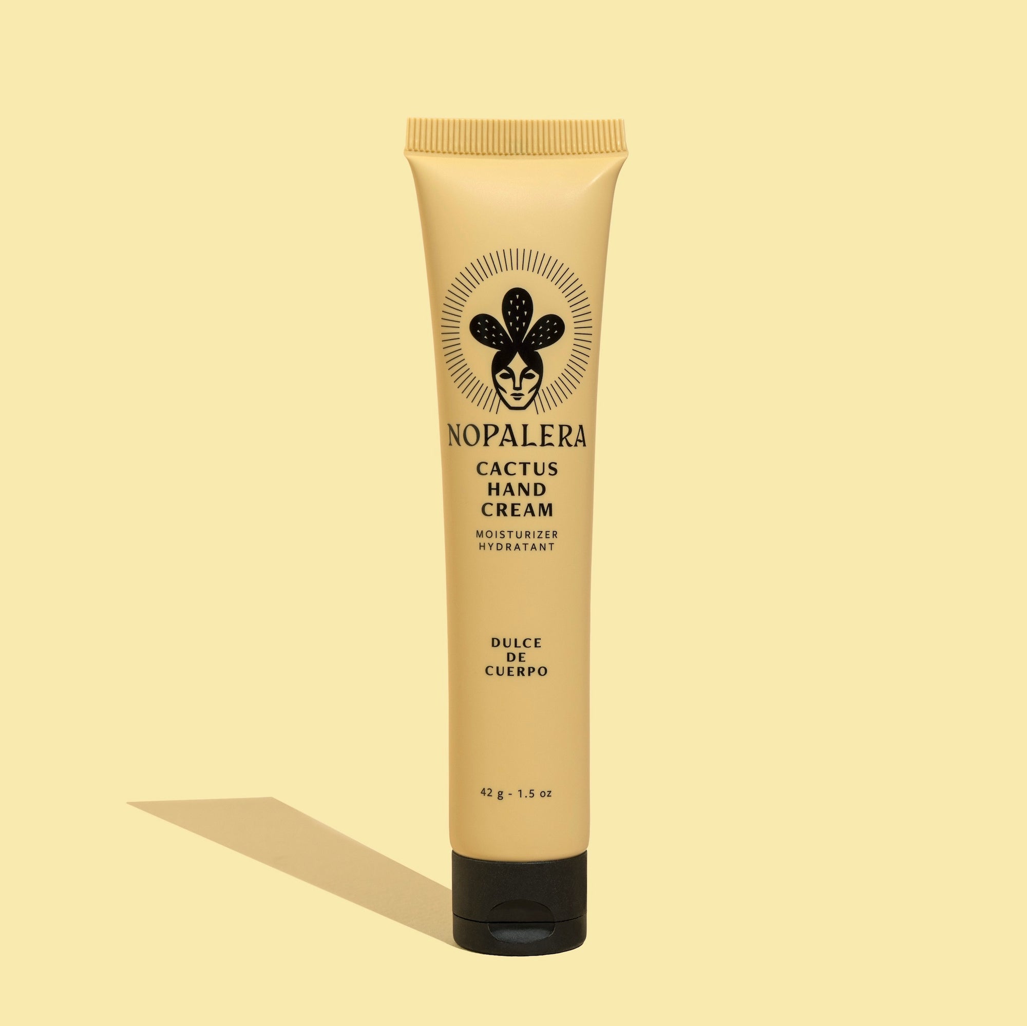 A tube of Nopalera Cactus Hand Cream Dulce de Cuerpo with a beige background, featuring the product name and an illustration of a cactus.