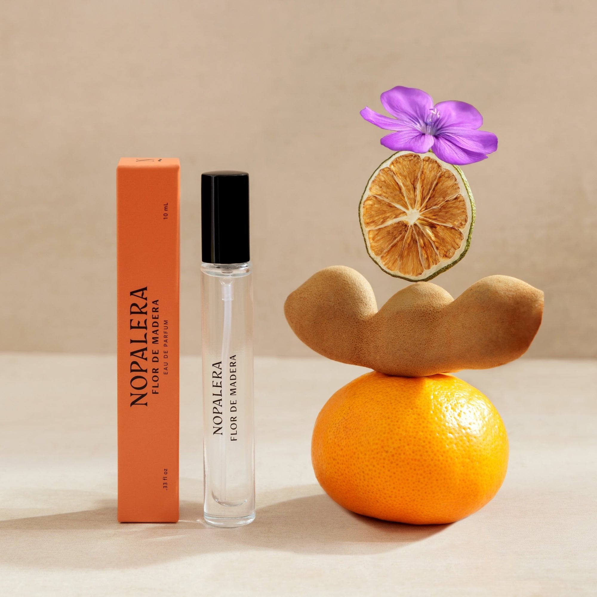 Nopalera  Luxury Mexican fragrance Flor de Madera travel perfume roller with orange, dried citrus, and flower representing fragrance notes