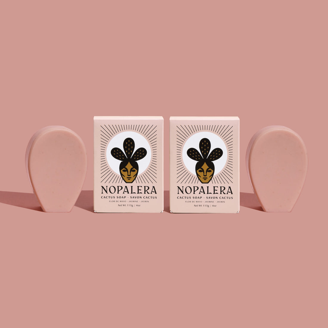 Two Nopalera cactus soap bars with matching blush-toned soap against a soft pink background.