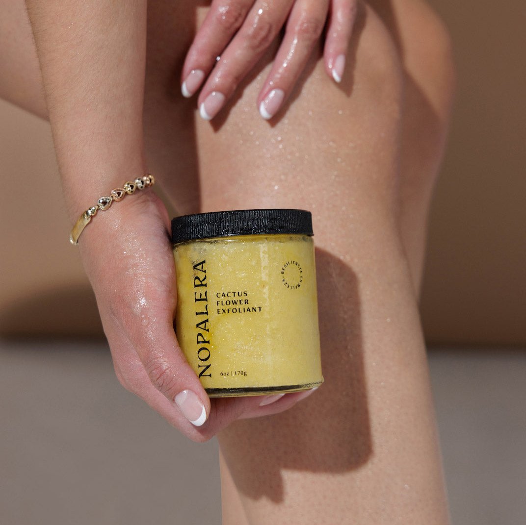 Nopalera Cactus Flower Exfoliant held beside sunlit, glowing skin.