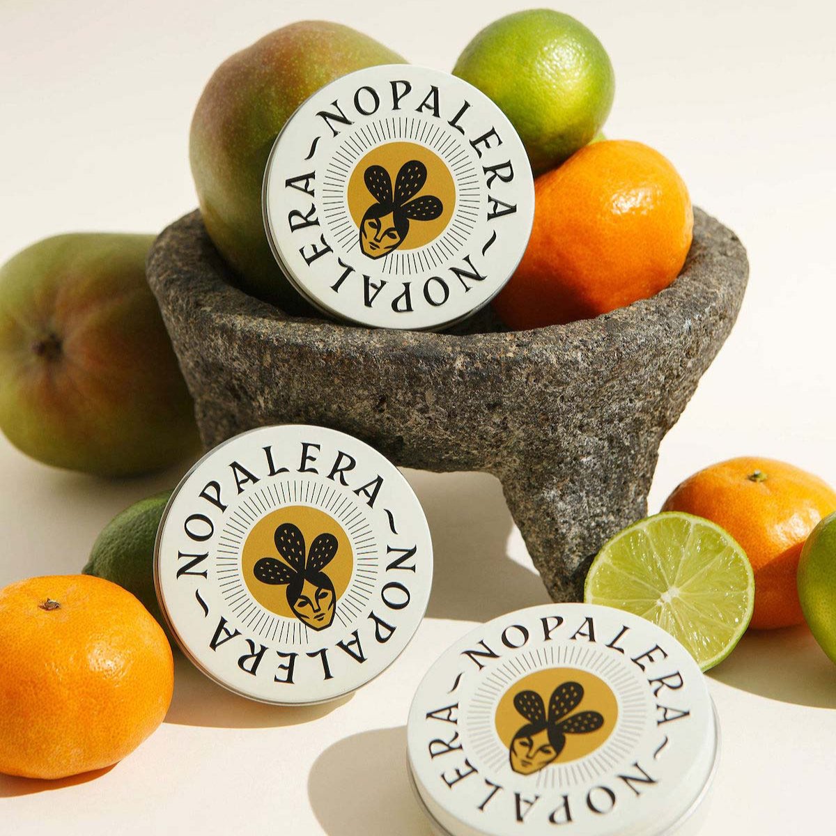 Nopalera citrus lotion bars displayed with oranges, lime, and tropical fruits.