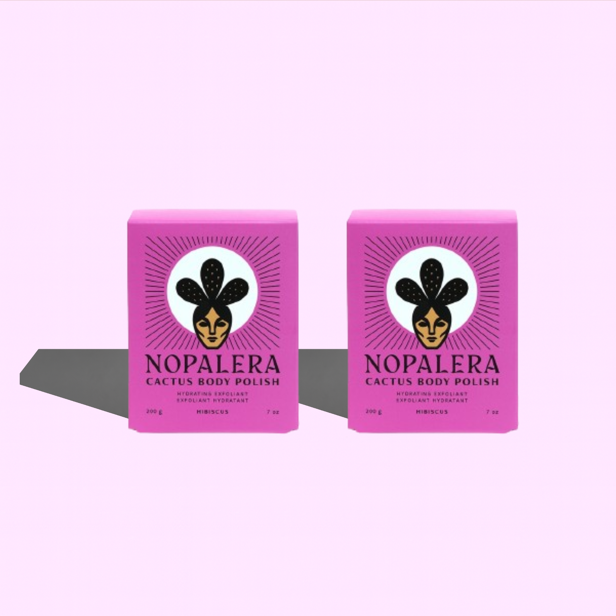 Two pink boxes of Nopalera Cactus Body Polish on a light purple background