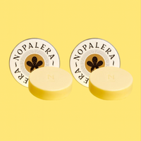 Two yellow citrus lotion bar with 'Nopalera' branding on a yellow background