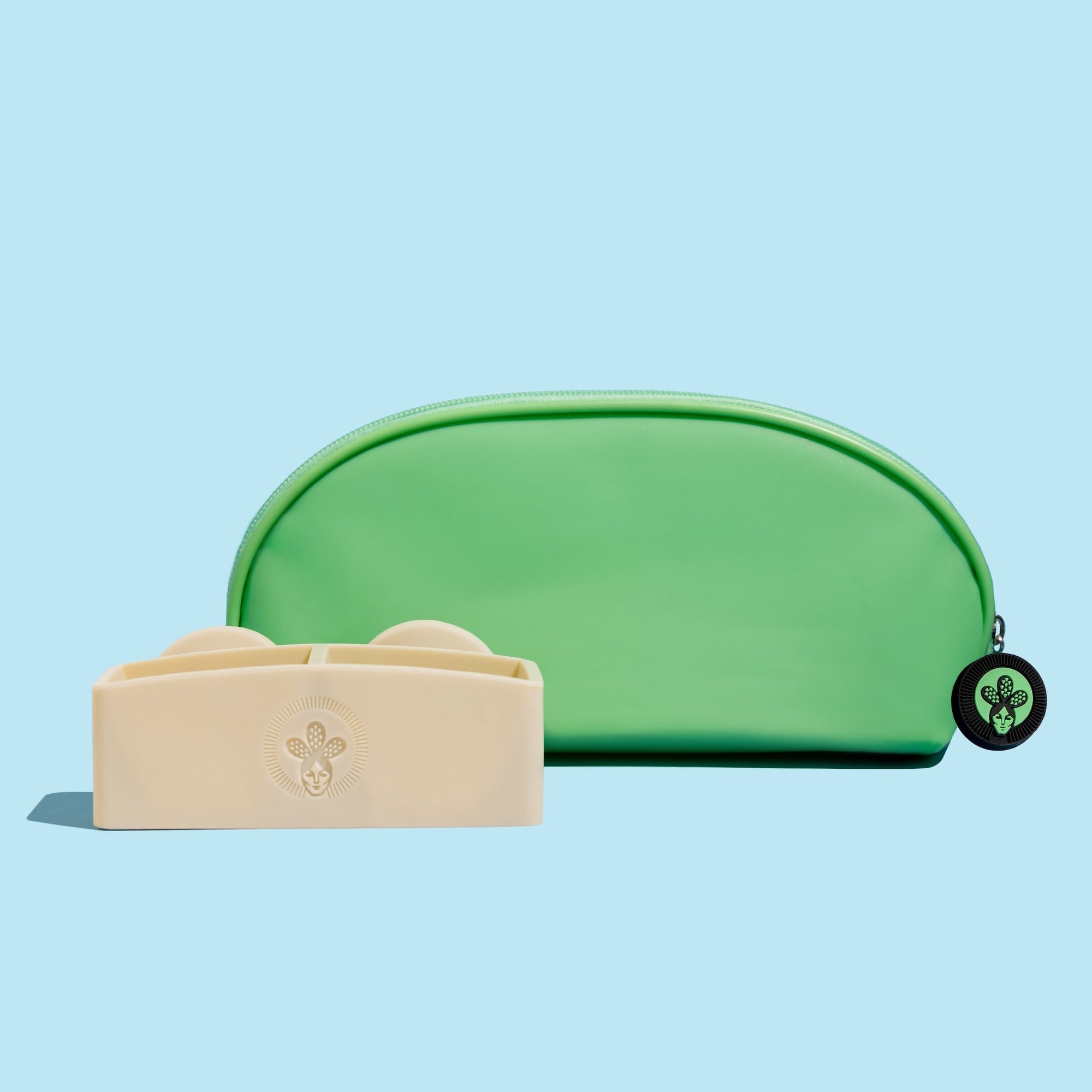 A silicone shampoo bar holder in beige color alongside a green jelly bag travel case designed for holding shampoo bars.