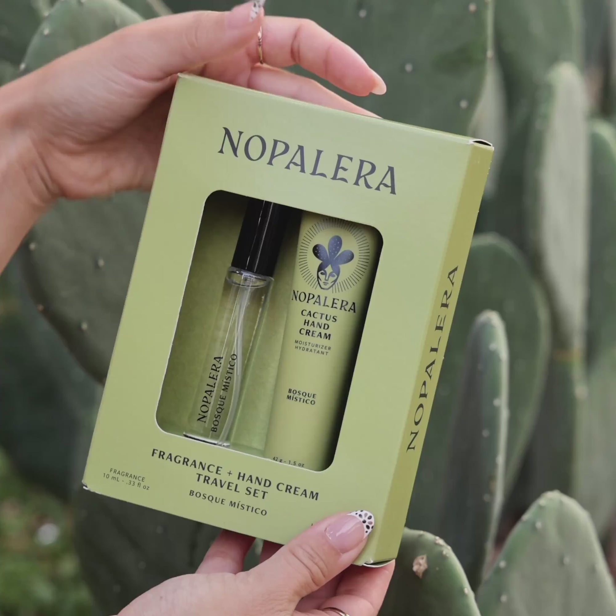 Person applying Nopalera cactus hand cream moisturizer in Bosque Místico scent with cactus plants in the background